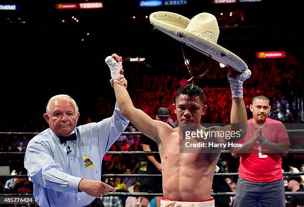 Alejandro Luna has his hand raised by referee Lou Moret after a fourth round TKO over Sergio Lopez of Mexico during a lightweigh bout at Staples...