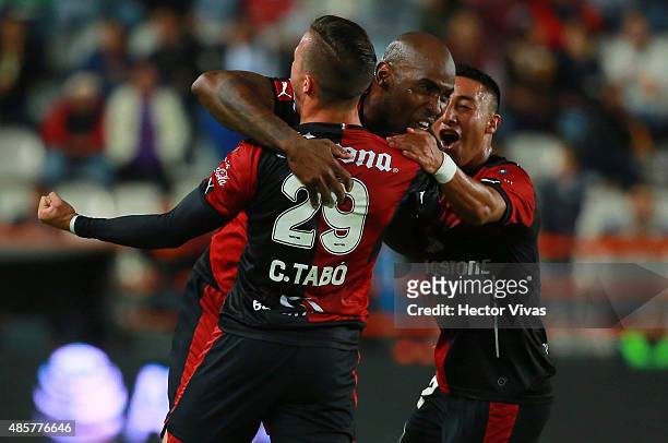 Felipe Baloy of Atlas celebrates with teammates after scoring the first goal of his team during a 7th round match between Pachuca and Atlas as part...