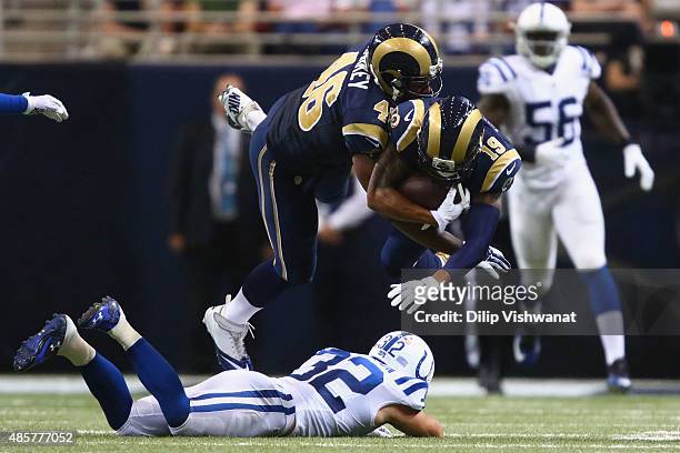 Cory Harkey of the St. Louis Rams runs into teammate Zach Laskey of the St. Louis Rams after he is tackled by Colt Anderson of the Indianapolis Colts...