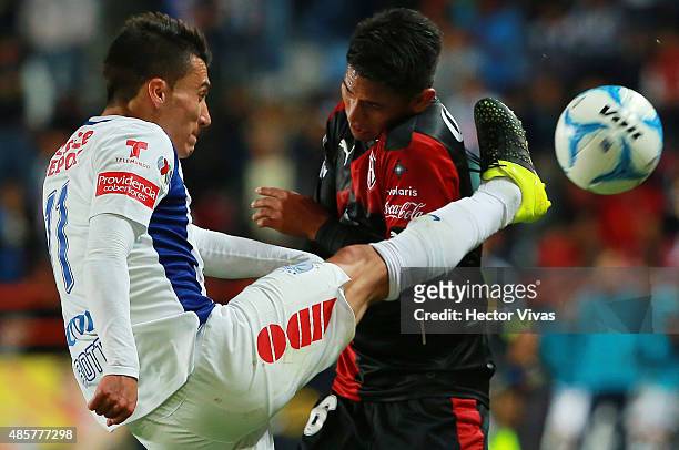 Ruben Botta of Pachuca struggles for the ball with Juan Carlos Valenzuela of Atlas during a 7th round match between Pachuca and Atlas as part of the...