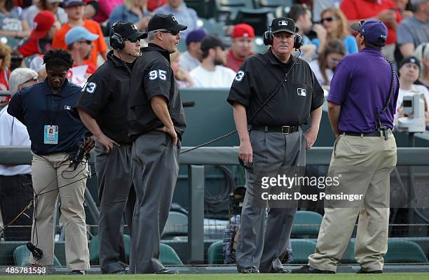 Umpires Todd Tichenor, Chris Segal and Tim Welke conduct a video replay and overturned a safe call on Corey Dickerson of the Colorado Rockies being...