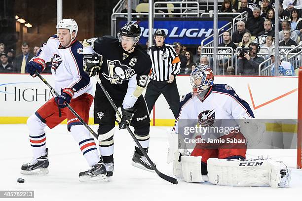 INikita Nikitin of the Columbus Blue Jackets and Sidney Crosby of the Pittsburgh Penguins battle for position as goaltender Sergei Bobrovsky of the...