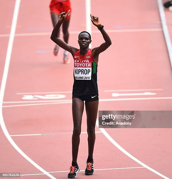 Helah Kiprop of Kenya celebrates after crossing the finish line to win silver in the Women's Marathon final during the '15th IAAF World Athletics...