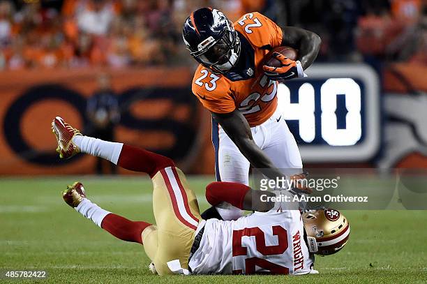 Ronnie Hillman of the Denver Broncos is tackled by Shareece Wright of the San Francisco 49ers during the second half of the Broncos' 19-12 win at...