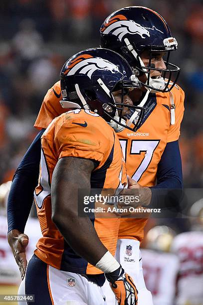 Juwan Thompson of the Denver Broncos celebrates his game-winning touchdown and two-point conversion against the San Francisco 49ers with Brock...