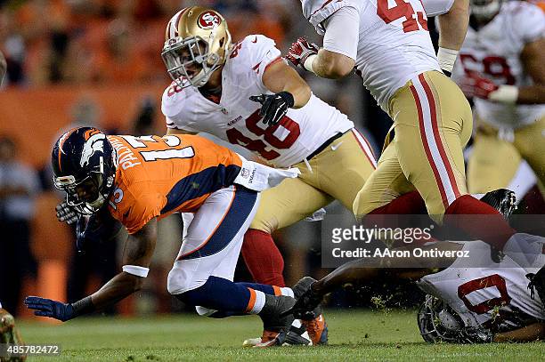 Nathan Palmer of the Denver Broncos is tackled by Rory Anderson of the San Francisco 49ers and Steve Beauharnais during the second half of the...