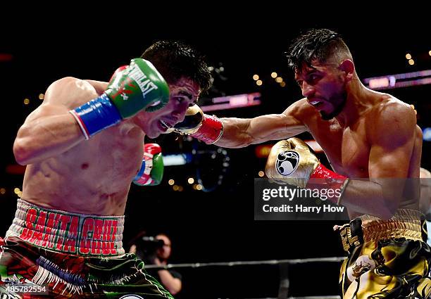 Abner Mares of Mexico punches Leo Santa Cruz during the seventh round of the WBC diamond featherweight and WBA featherweight championship bout at...