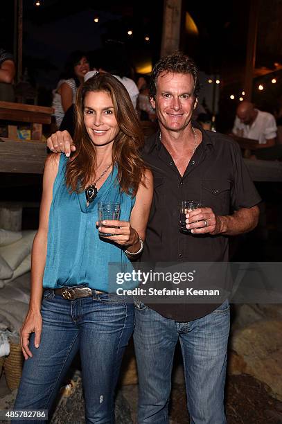 Cindy Crawford and Rande Gerber attend Kelly Slater, John Moore and Friends Celebrate the Launch of Outerknown at Private Residence on August 29,...