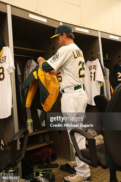 Josh Lindblom of the Oakland Athletics gets ready in the clubhouse prior to game two of a day-night double header against the Cleveland Indians at...