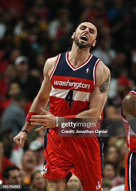 Marcin Gortat of the Washington Wizards celebrates hitting a shot in the final minute against the Chicago Bulls in Game One of the Eastern Conference...