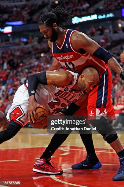 Taj Gibson of the Chicago Bulls tries to move against Nene of the Washington Wizards in Game One of the Eastern Conference Quarterfinals during the...