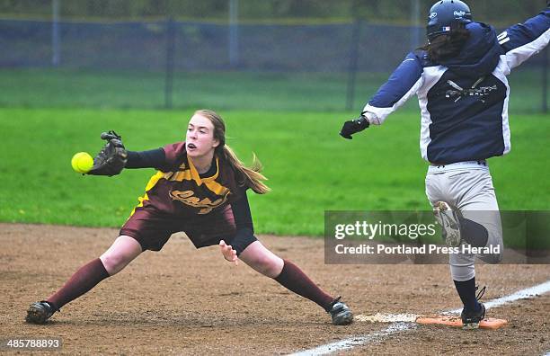 Gabe Souza/Staff Photographer: Cape Elizabeth first baseman Elise Flathers stretches to get the throw but can't quite beat Yarmouth's Lauren...