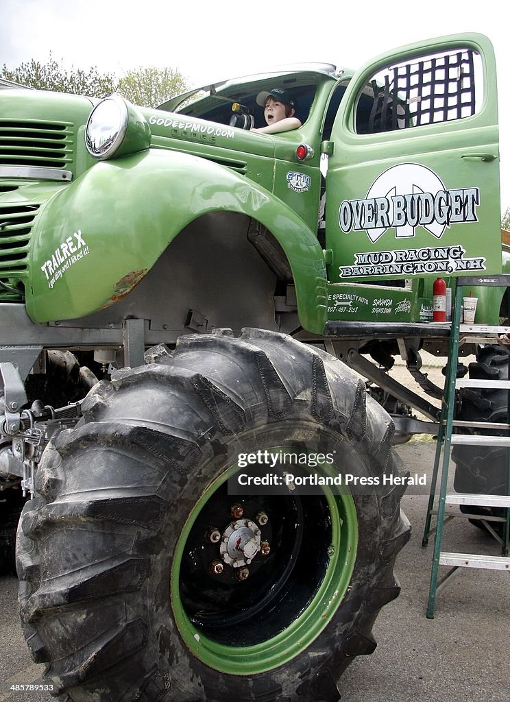 Eli Tetreault, 6, peeks out from the drivers seat of a giant monster mud truck on display at the Le