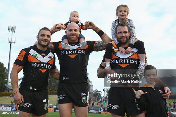 Robbie Farah, Keith Galloway and Pat Richards of the Wests Tigers pose after the match during the round 25 NRL match between the Wests Tigers and the...