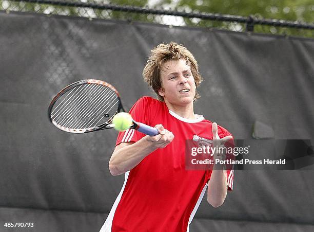 Jill Brady/Staff Photographer: Joe Corbeau of Scarborough makes contact while competing with doubles partner Jeff Sirocki during the state tennis...