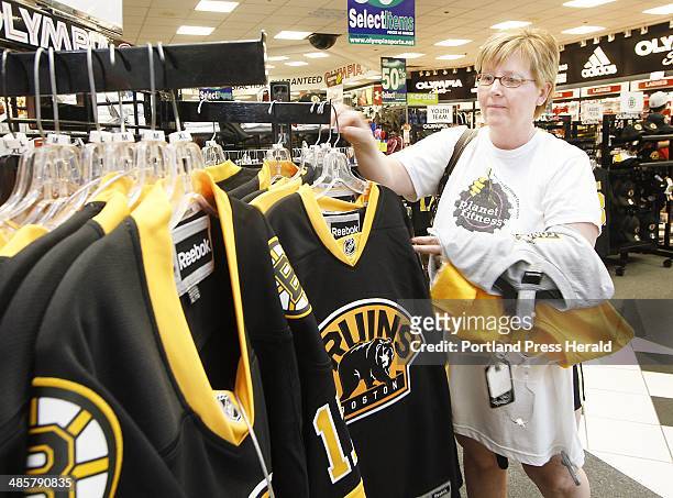 Staff Photo by Derek Davis: People shop for Boston Bruins apparel at the Maine Mall in South Portland. Teresa Tucci of South Portland shops at...