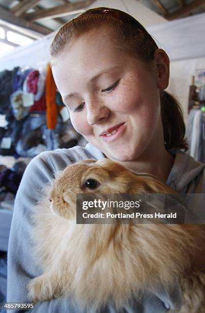 Jill Brady/Staff Photographer: Evelyn Townsend of Fairfield snuggles with a French/German angora rabbit while visiting the Underhill Fiber Farm of...