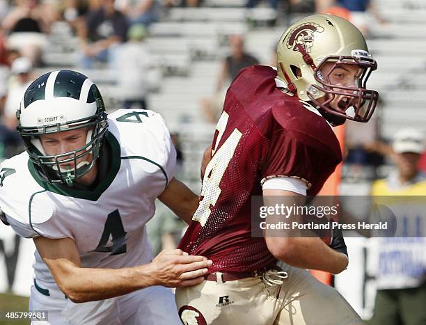 Staff photo by Derek Davis: Bonny Eagle at Thornton Academy football. Tyson Goodale of Bonny Eagle tries to stop TA's Nick Kenney as he breaks free...