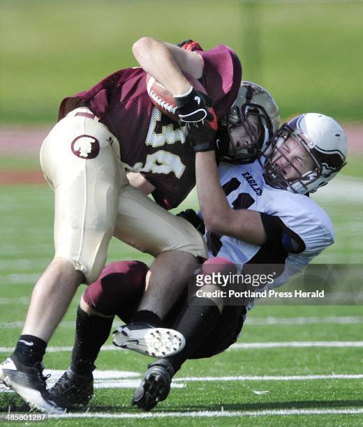 Staff Photo by Shawn Patrick Ouellette: Thornton Academy's Nick Kenney is hit by Windham's Todd Allen Saturday, September 17, 2011.