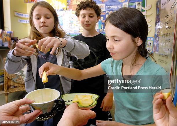 Photo by John Ewing/Staff Photographer -- Students at Portland's Levy Day School commemorate the Jewish holiday of Rosh Hashana on Thursday. Emma...