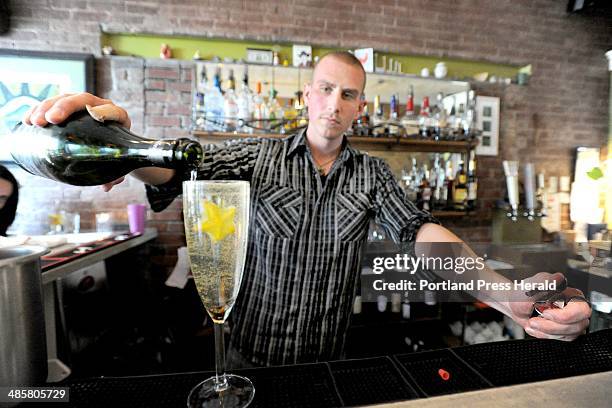 John Patriquin /Staff Photographer; Tuesday, 3/29/11. Bartender Kyle Miron mixes a house speciality called starfruit sparkler at Figa in Portland.