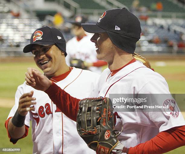 Staff Photo by Derek Davis: Rock Cats vs Sea Dogs in Portland. Ryan Dent, left, greets teammate Mitch Dening after Dening made a catch on a fly ball...