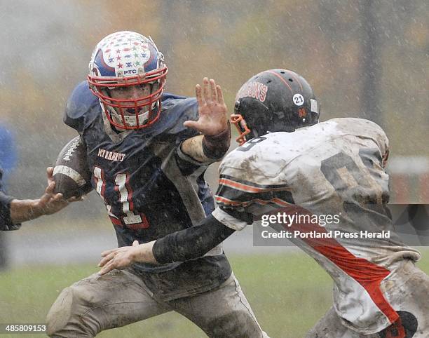 Staff Photo by Shawn Patrick Ouellette: Mt. Ararat's Drew Marshall tries to stiff Tom Wiley of Brunswick Saturday, Oct. 24, 2009.