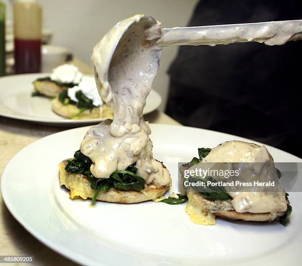 Tim Greenway/Staff Photographer: The smoky bacon cream is poured over the poached eggs -- Porthole Executive Chef Paul Dyer prepares eggs florentine...