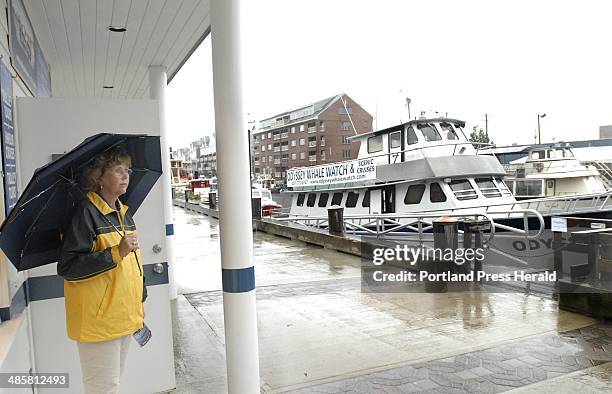 John Patriquin/Staff Photographer; Thursday, July 2009. Portland Discovery Land & Sea Tours Judy Anderson braves a downpour while waiting for...