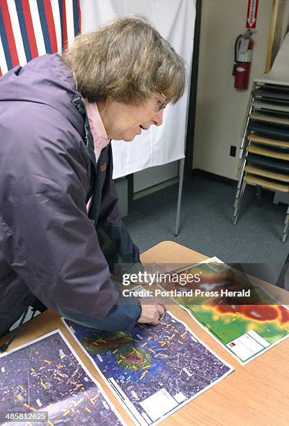 Photo by John Patriquin/Staff Photographer -- Judy Dann, first selectman in Dixmont, looks over impact maps and talks about the local vote to...