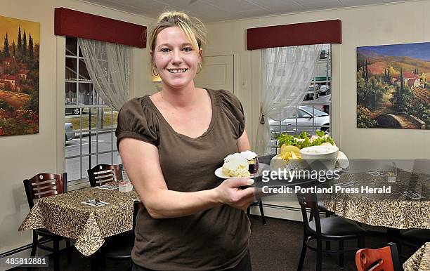 Gordon Chibroski/Staff Photographer -- Rebecca Howard, a waitress and cook for 10 years at the Corsican in Freeport, shows one of the restaurant's...