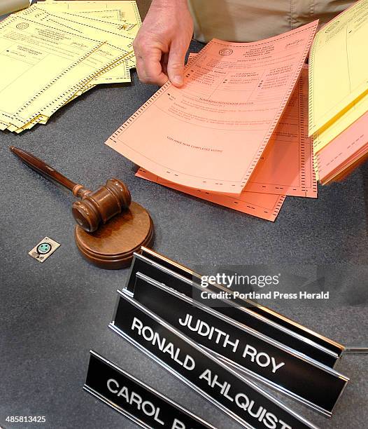 Photo by Doug Jones/Staff Photographer -- Dave Corbeau sorts ballots for the recount in Scarborough. The slot-machine question lost by 240 votes.