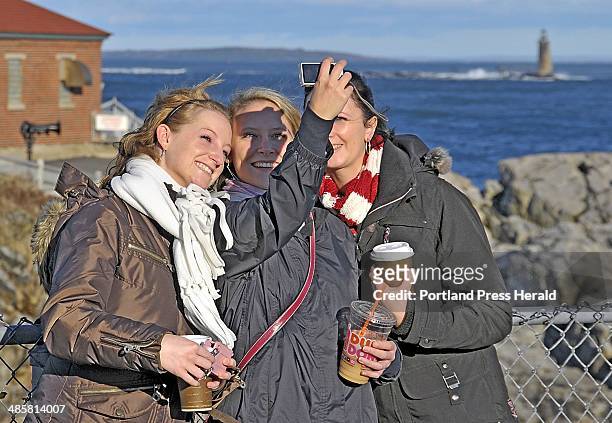Gordon Chibroski/Staff Photographer -- Sonja Krakau of Cologne, Germany, a student at SMCC, takes a picture of herself with Miriam Blum, left, and...