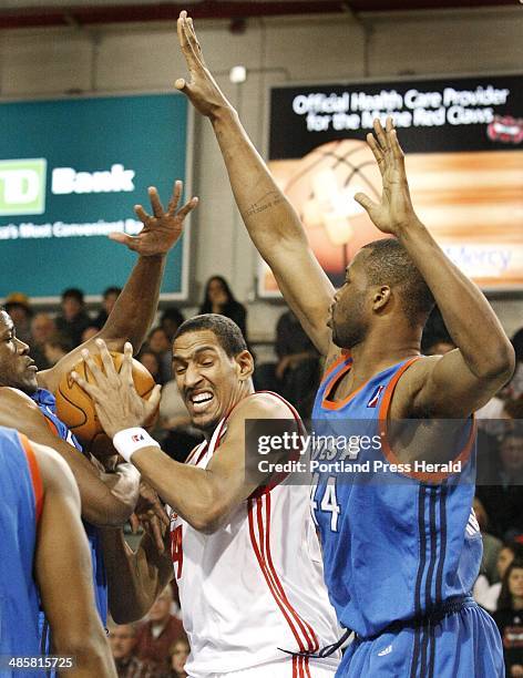 Jill Brady/Staff Photographer: -- Maine Red Claws Alexis Ajinca tries to plow through Tulsa 66ers DeVon Hardin during first half action at the...