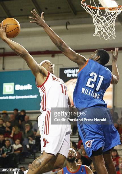 Jill Brady/Staff Photographer: -- Maine Red Claws Will Blalock attempts to get around defense from Tulsa 66ers Latavious Williams during the first...