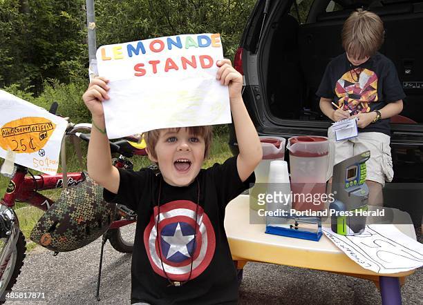 Carl D. Walsh/Staff Photographer: Four year-old Griffin Marley tries to attract business as his brother Cooper, 7 does some bookkeeping at roadside...