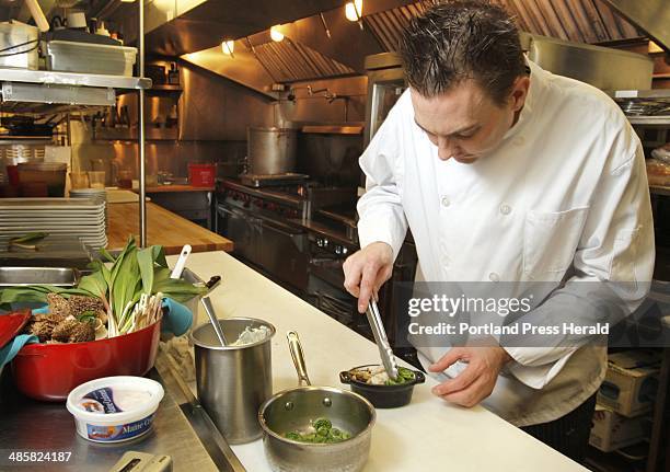 Gregory Rec/Staff Photographer: -- Jeffrey Savage, executive chef at On the Marsh Bistro in Kennebunk, arranges fiddleheads in an appetizer called...