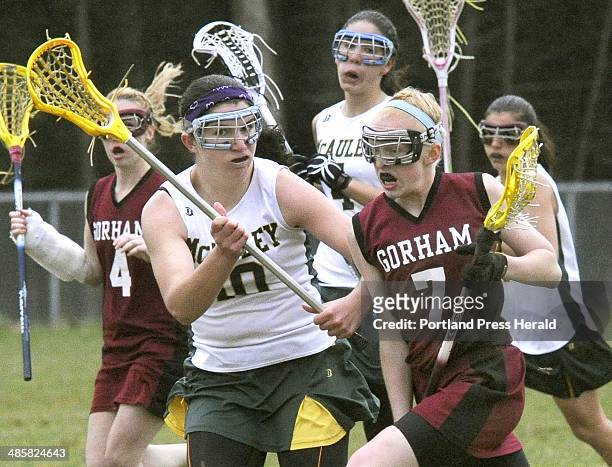 John Patriquin/Staff Photographer -- Shannon Wilcox of Gorham attempts to get past Michele Girard of McAuley during their girls' lacrosse game...