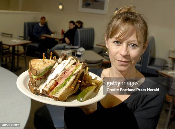John Patriquin/ Staff Photographer: Monday, March 2009. Server Judy Dyer displays a turkey club on rye at Bernie's Place in Falmouth for Eat and Run....