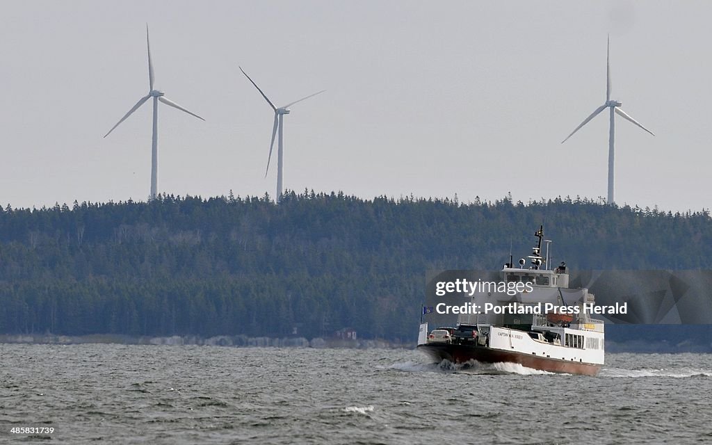 Three new wind turbines loom over a return