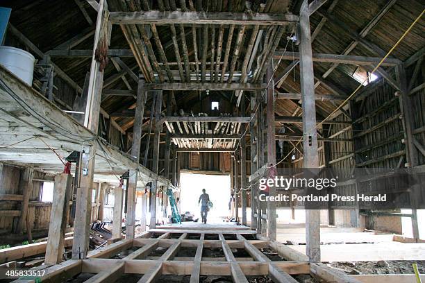 Jill Brady/Staff Photographer: -- Jon Courtney walks into the dairy barn at Broadturn Farm in Scarborough on Wednesday, June 17, 2008. The farm is...