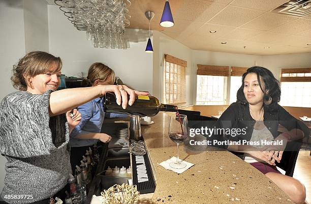John Patriquin /Staff Photographer.Thurs. ,4//28/11. Bartender Zeus-Hannah Suzette pours a glass of red wine as Bianca Gonzalez looks on at Azure...
