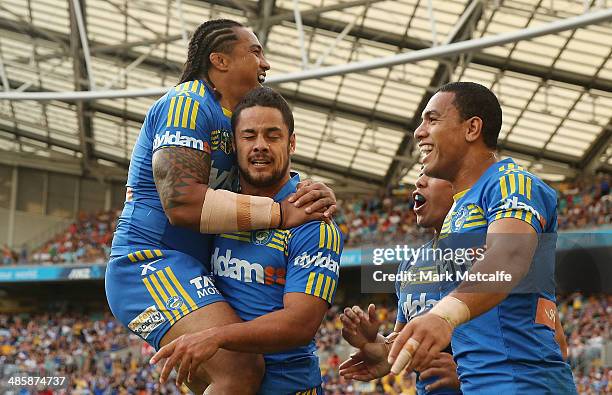 Jarryd Hayne of the Eels celebrates with team mates Fuifui Moimoi and Will Hopoate after scoring his second try during the round seven NRL match...