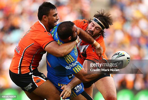 Tim Mannah of the Eels offloads as Aaron Woods of the Tigers defends during the round seven NRL match between the Parramatta Eels and the Wests...