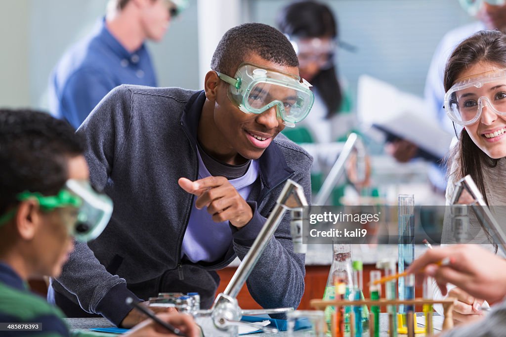 Multi racial students in chemistry class wearing safety glasses