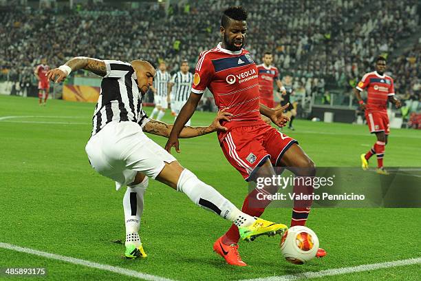 Arturo Vidal of Juventus competes with Arnold Mvuemba of Olympique Lyonnais durig the UEFA Europa League quarter final match between Juventus and...