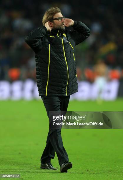 Dortmund coach Jurgen Klopp cups his ears to the crowd following their defeat in the UEFA Champions League Quarter Final second leg match between...