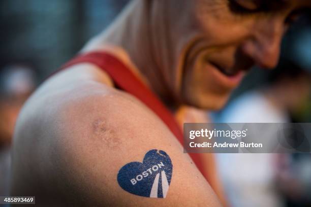 Runner with a temporary Boston Marathon tattoo gets ready to run the 118th Boston Marathon in the Boston Commons on April 21, 2014 in Boston,...