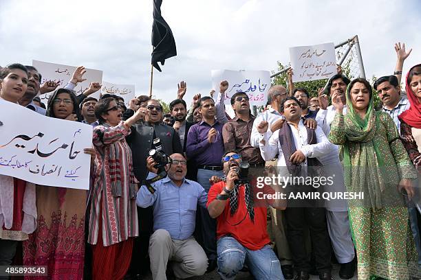 Pakistani journalists shout slogans during a protest against the attack on television journalist Hamid Mir by gunmen, in Islamabad on April 21, 2014....