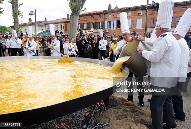 Members of the brotherhood of the Bessieres' giant Easter omelette prepare a giant omelette with thousands of eggs, on April 21, 2014 in Bessieres,...